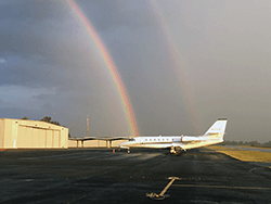 Airport runway with rainbow